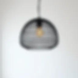 Sleek black woven light fixture against a minimalist background